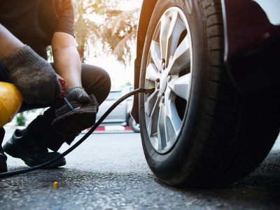 Technician is inflate car tire - car maintenance service transportation safety concept